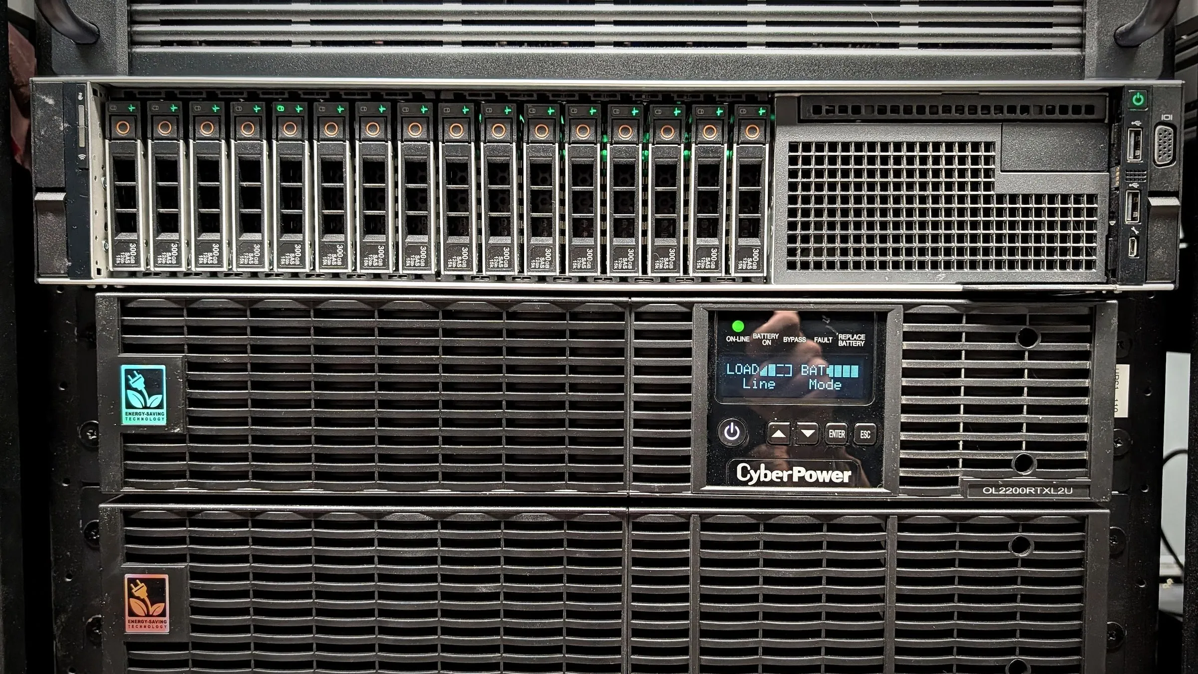 Rack-mounted UPS with an extended battery pack below it, protecting a server in a network rack